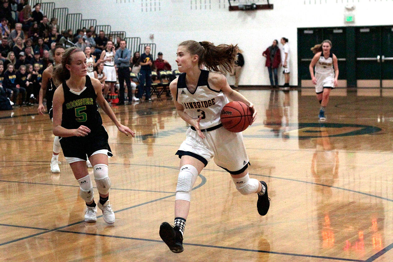 Luciano Marano | Bainbridge Island Review - Spartan sophomore Ellie Woolever drives toward the hoop during Fridays home game against Roosevelt.