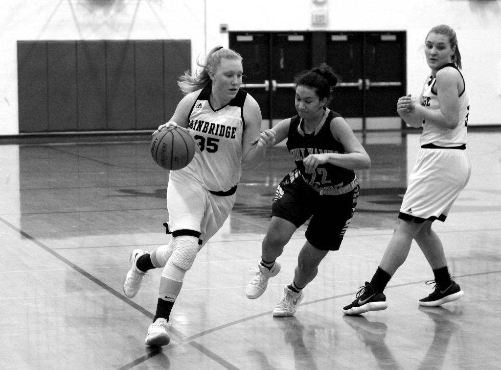 Luciano Marano | Bainbridge Island Review - Spartan freshman Anna Kozlosky drives toward the hoop during Tuesdays home game.                                 Luciano Marano | Bainbridge Island Review - Bainbridge High School girls varsity basketball Head Coach Henry Guterson chats with the squad between quarters Tuesday.                                 Luciano Marano | Bainbridge Island Review - Bainbridge sophomore Kendall Havill shoots a free throw Tuesday.