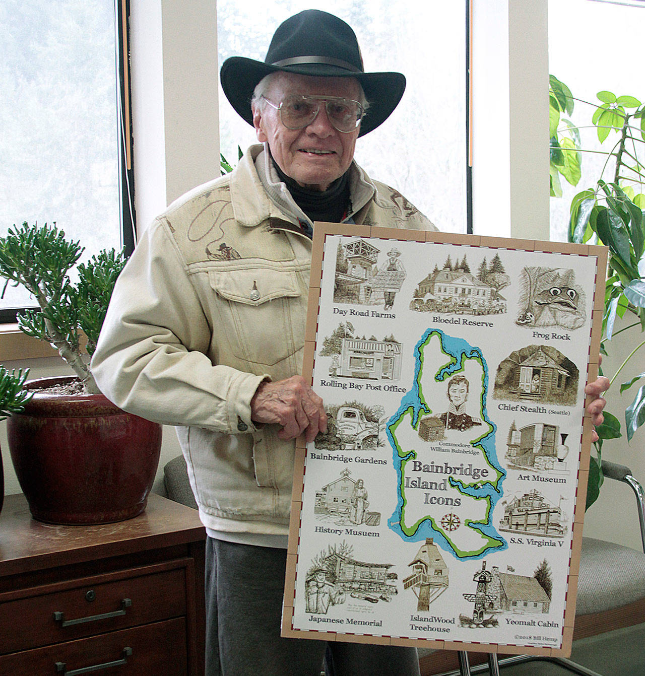 Artist Bill Hemp displays his new poster of sketches that illustrate a map of Bainbridge Island. (Luciano Marano | Bainbridge Island Review)