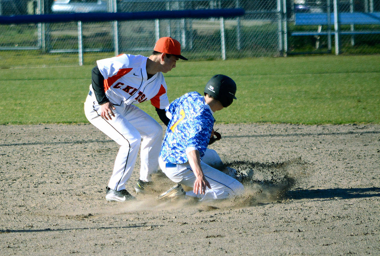 Central Kitsap shortstop Fred Buckson tags out Bainbridge baserunner Theo Colgan. (Mark Krulish | Kitsap News Group)