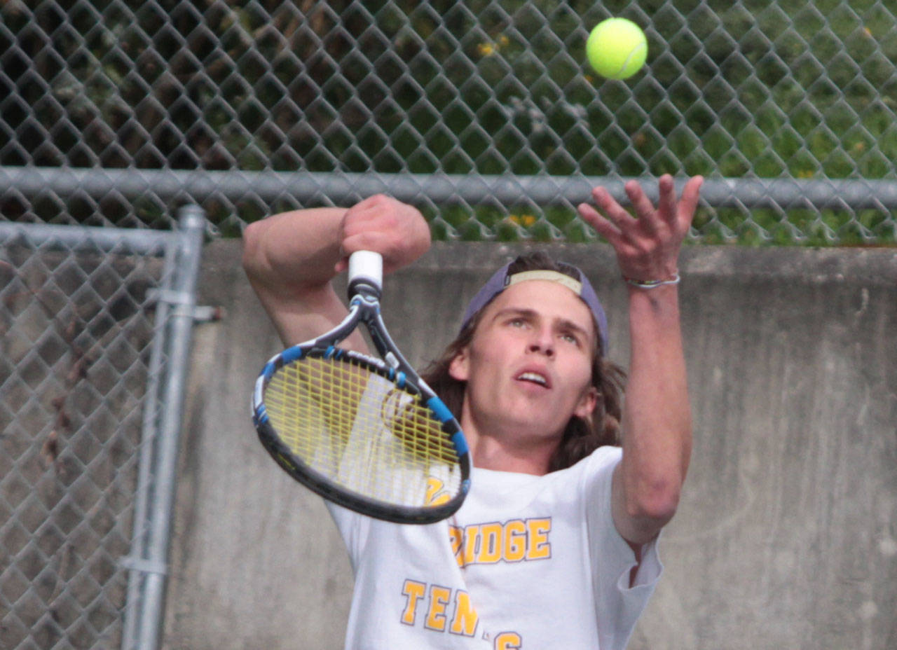 The Spartans Luke Hurd serves during his boys singles matchup against Lakeside. (Brian Kelly | Bainbridge Island Review)