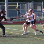 Mackenzie Chapman works to regain control of the ball in front of the Ballard goal. (Brian Kelly | Bainbridge Island Review)