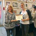 Dinah Satterwhite presents Adda Amelang with the Youth Art Award Grand Prize. (Photo courtesy of the Bainbridge Island Studio Tour)