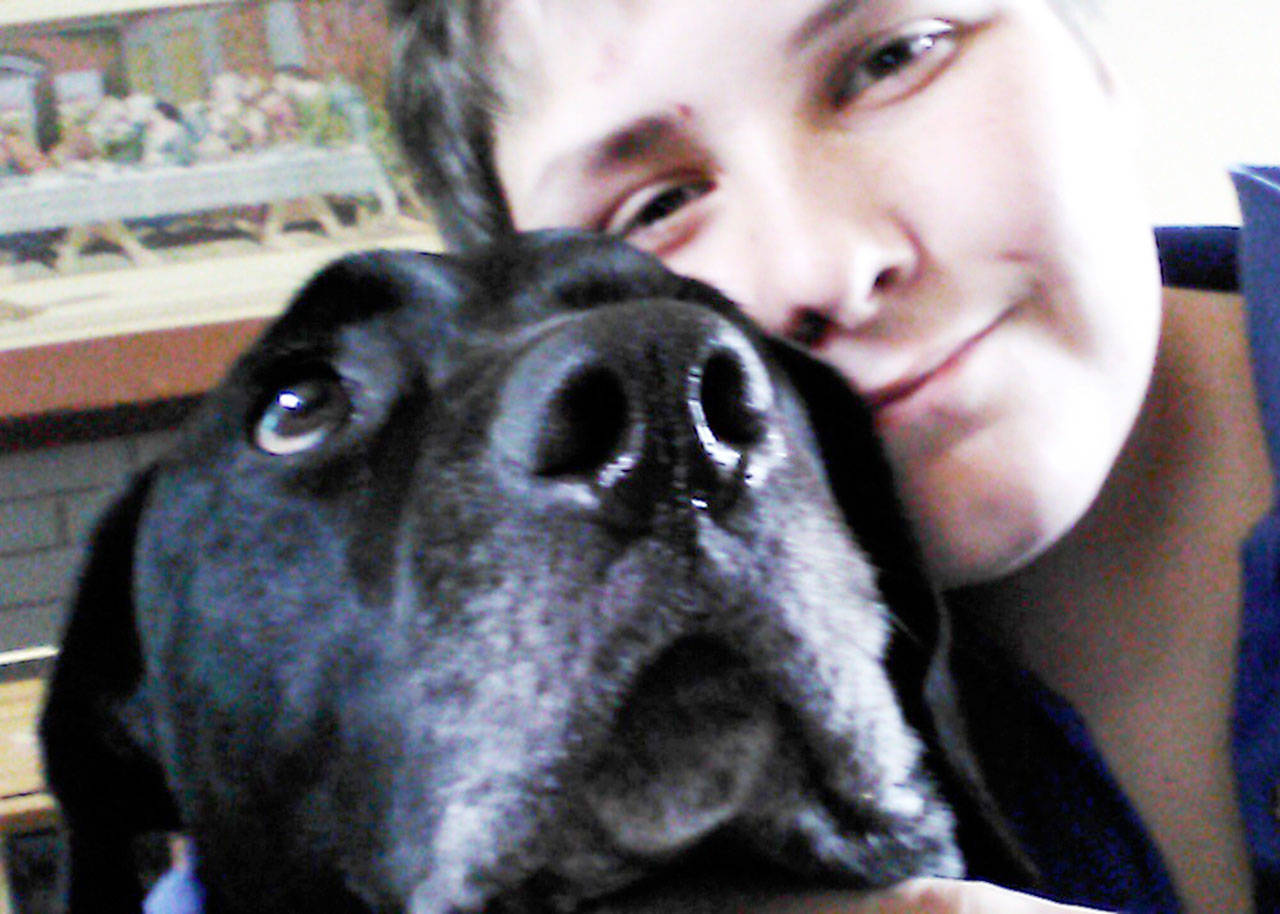 Dakota Braun, 14, is happily reunited with his dog Mowgli thanks to staff members at Kitsap Humane Society, who checked the canines pet license. (Kitsap Daily News photo)