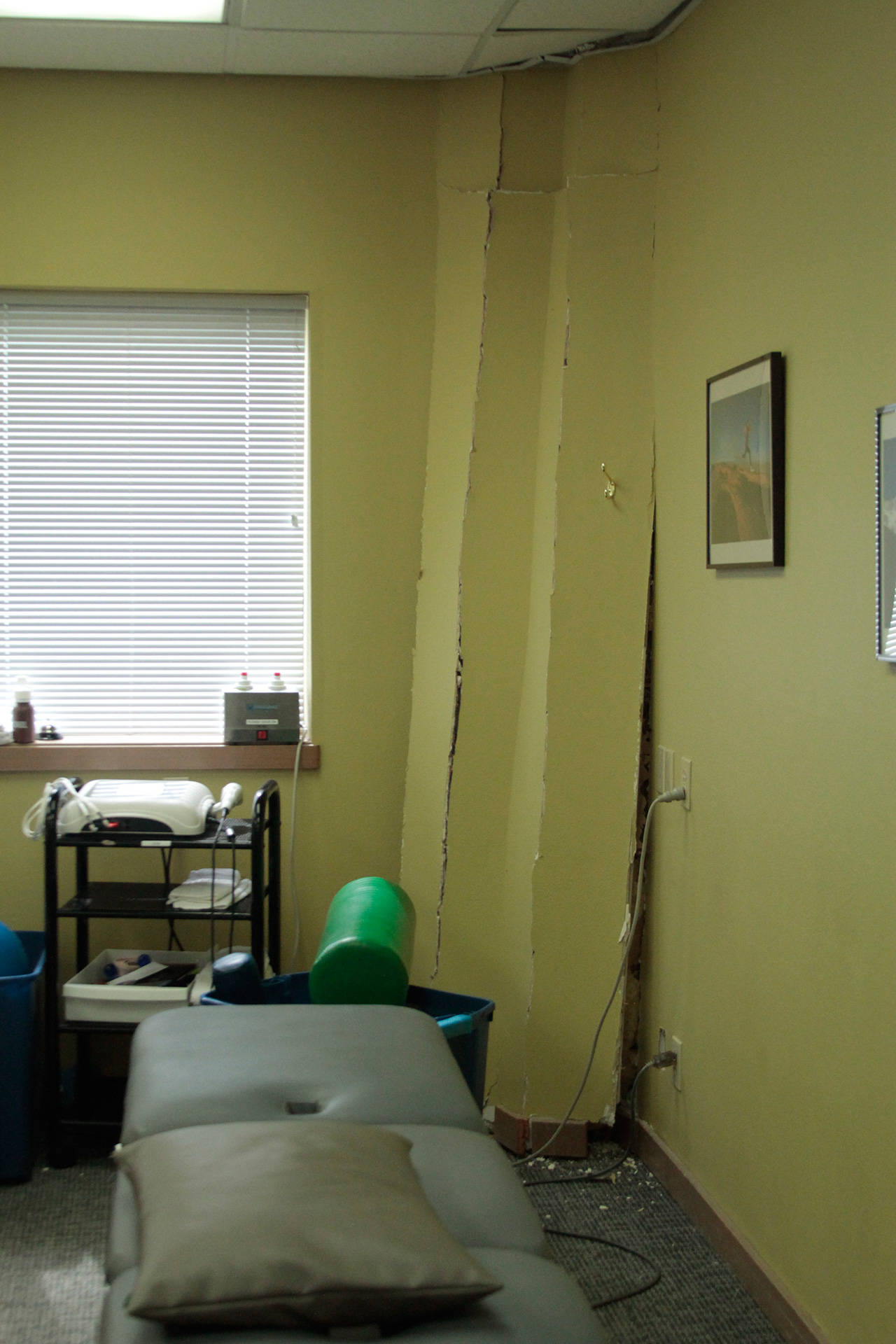 A wall inside the office of Kitsap Physical Therapy was heavily damaged after a vehicle struck the outside of the 911 Hildebrand Building Wednesday. (Luciano Marano | Bainbridge Island Review)