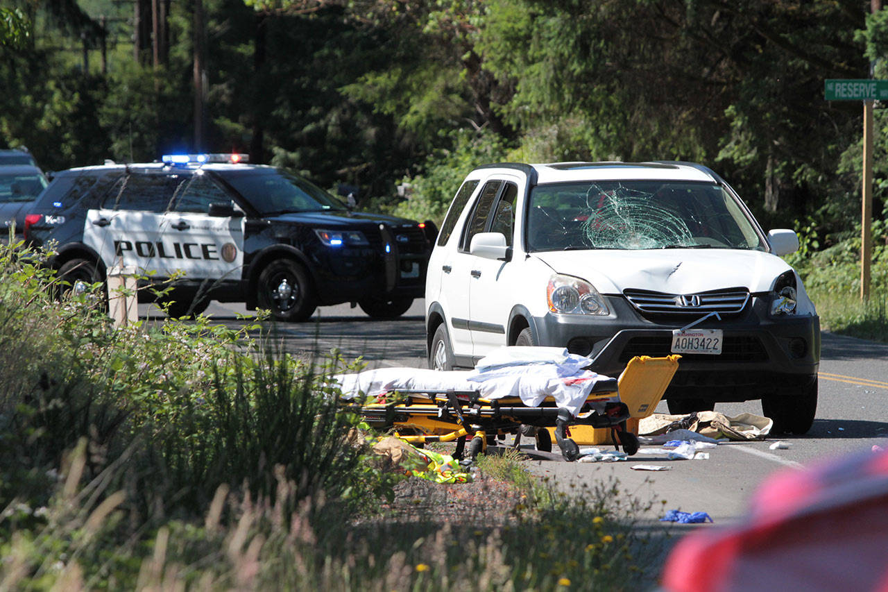 The vehicle that struck two joggers remains in the roadway on Finch Roach during the investigation into the crash on Fathers Day. (Brian Kelly | Bainbridge Island Review)