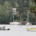 Derelict, dangerous boat towed from island waters to Seattle