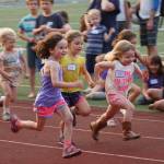 Luciano Marano | Bainbridge Island Review - Young sprinters dash toward the finish line during the 60-meter event at the final Kiwanis All-Comers Track Meet of the year Monday, Aug. 13 at Bainbridge High School.