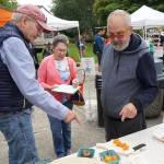 Luciano Marano | Bainbridge Island Review - Anthony and Christine Farrell and Bob Ross, the judges of this years farmers market Tomato Taste Off, discuss an entrant Saturday, Aug. 25.