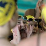 Spartan swimmers and divers do a team cheer before the start of the home meet against Ballard. (Brian Kelly | Bainbridge Island Review)