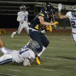 Max McLeod takes an Ingraham defender along for a ride as he picks up more yardage for the Spartans in Fridays 44-22 win. (Brian Kelly | Bainbridge Island Review)