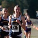Luciano Marano | Bainbridge Island Review - Bainbridge High School varsity cross country team co-captain Liz Messinger, trailed closely by Eleanor Collins, round a bend about halfway through the Battle Point Park cross country course.