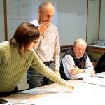 Architect Charlie Wenzlau, center, watches as Jane Rein, a member of the Design Review Board, asks about the original site plans for the hotel property on Hildebrand Lane. (Brian Kelly | Bainbridge Island Review)