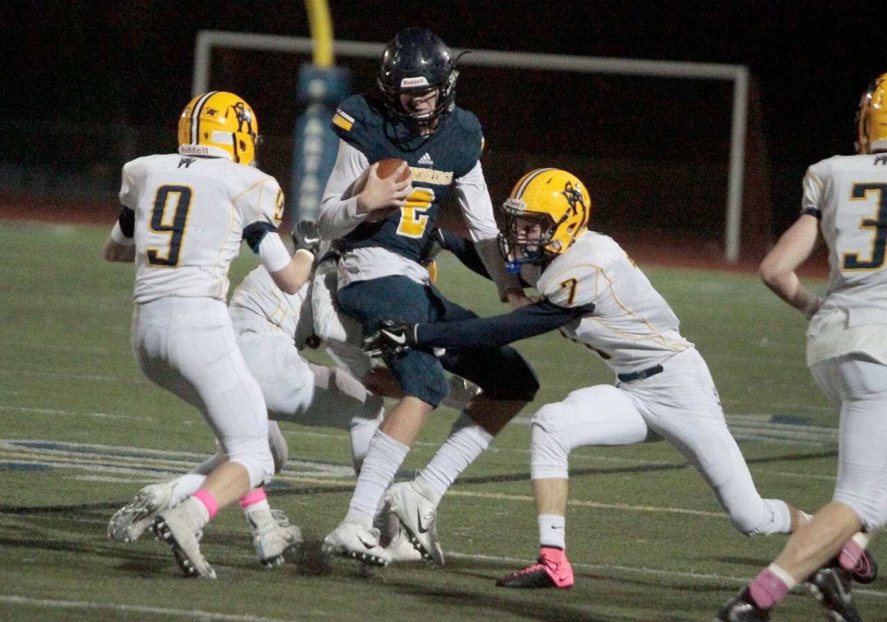 Luciano Marano | Bainbridge Island Review - Spartan senior QB Gannon Winker tries to twist through the West Seattle defensive line Friday.
