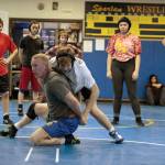 Luciano Marano | Bainbridge Island Review - Bainbridge High School wrestling Head Coach Dan Pippinger demonstrates a move during a recent practice session.