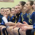 The Spartan gymnastics team watches as a teammate warms up on the balance beam. (Brian Kelly | Bainbridge Island Review)