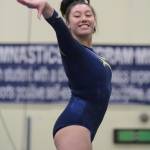 Mariko Ronan competes on the balance beam during the Spartans final home gymnastics meet before the holiday break. (Brian Kelly | Bainbridge Island Review)