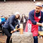 Luciano Marano | Bainbridge Island Review - Shoichi Sugiyama, a volunteer with the Bainbridge Island Japanese American Community and staple figure at the islands annual New Years mochi tsuki event, turns the mashed sweet rice between mallet strikes by Joya Holtz, of Bainbridge.