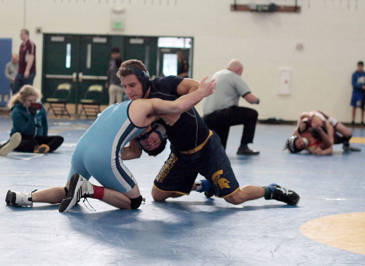 Luciano Marano | Bainbridge Island Review - Spartan team captain Oleg Maguire pinned Interlakes Miguel Ortiz in 2:57 during his first match at this years Island Invitational wrestling tournament Jan. 12. He went on to take first place in his weight bracket (138-pounds).