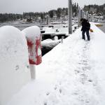The city dock on Eagle Harbor is covered with snow Saturday. (Luciano Marano | Bainbridge Island Review)