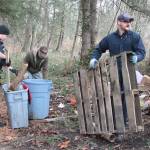 Bainbridge police work to clean up the site of a former homeless camp next to Highway 525 Monday morning.                                (Brian Kelly | Bainbridge Island Review)