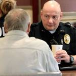 Bainbridge Police Chief Jeff Horn talks to an island resident last year during a session of the Coffee with a Cop program. (Brian Kelly | Bainbridge Island Review)