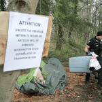 Bainbridge police clean up the remains of a homeless camp near High School Road in late Feburary. Cases of unsheltered homelessness have risen in the past year, according to a recent county survey on the number of homeless people in Kitsap.(Brian Kelly | Bainbridge Island Review)