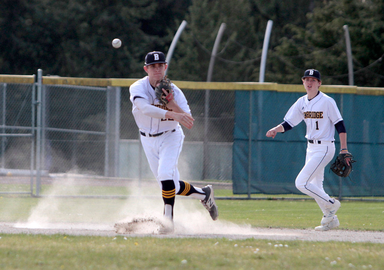 Luciano Marano | Bainbridge Island Review - Spartan junior Jonathan Kussie lobs the ball toward first base during the island varsity squads recent loss to Eastside Catholic.