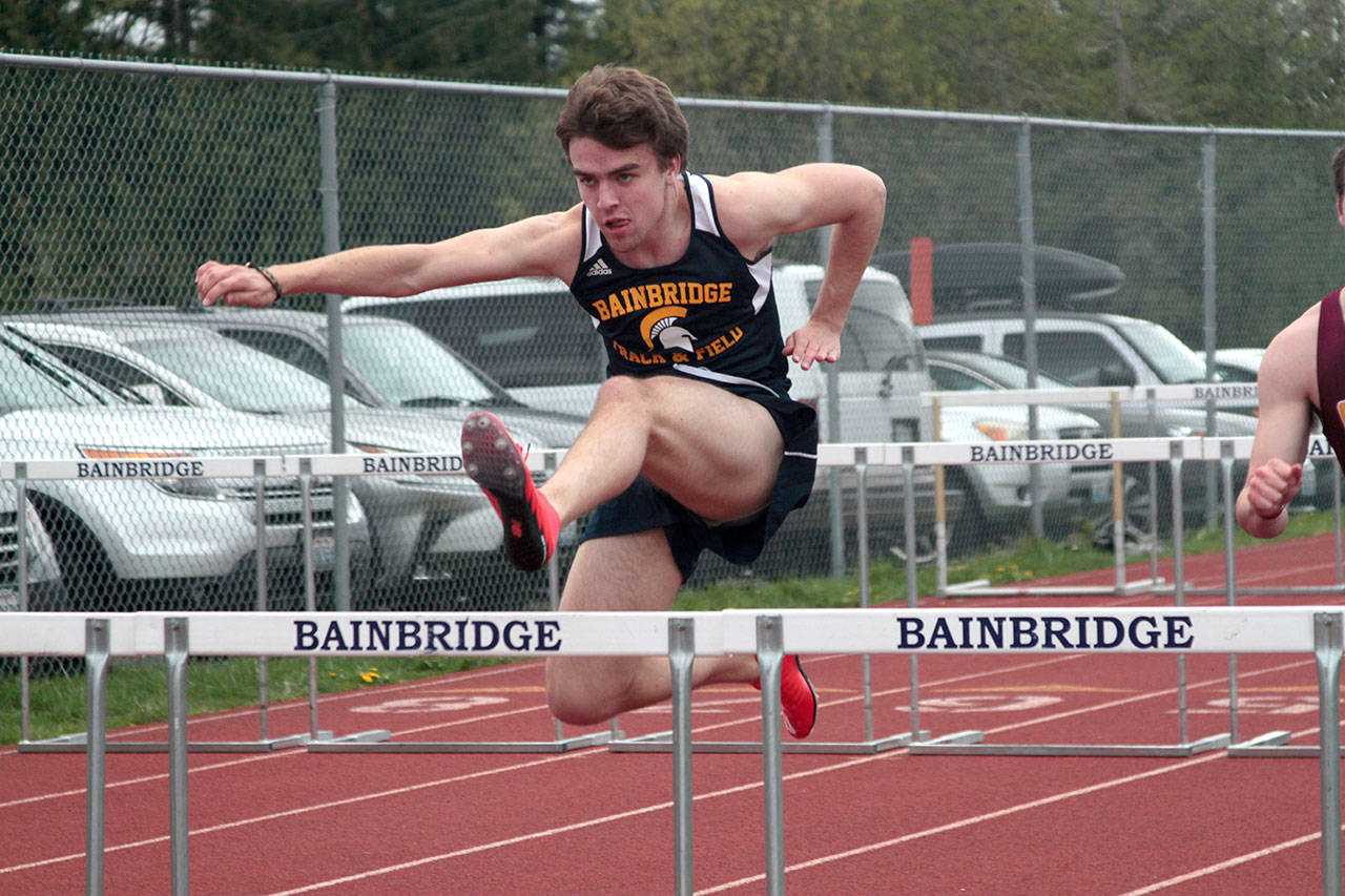 Luciano Marano | Bainbridge Island Review - Bainbridge Islands Sean Lindsey runs the hurdles during last weeks home meet.
