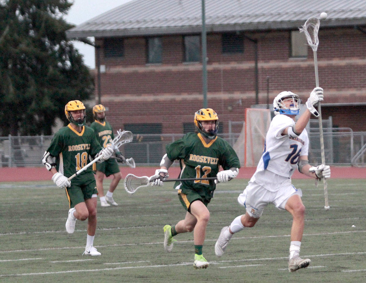 Luciano Marano | Bainbridge Island Review - Bainbridges Cole Emerson reaches for the ball during last weeks home match against Roosevelt.