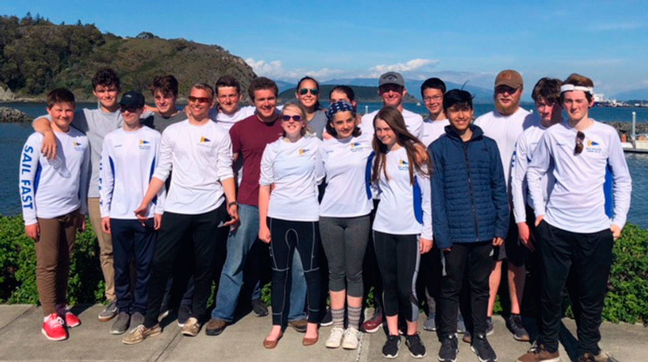 Anne Doane photo | The 2019 Bainbridge High School sailing - Jack Bennett, Captain Max Doane, Jack Turkovich, Dane Petrakis, Banning Jones, Chase VanDerrick, Gus Beer, Lindsay Campbell, Grace Frei, Lola White, Lauren Heinzelman (eclipsed), Gianna Dewey, Captain Zach Cooper, Evan Yeung, Thomas McNulty, Camden Lee, Trevor Royset, and Barrett Lhamon - at their final regatta of the year.
