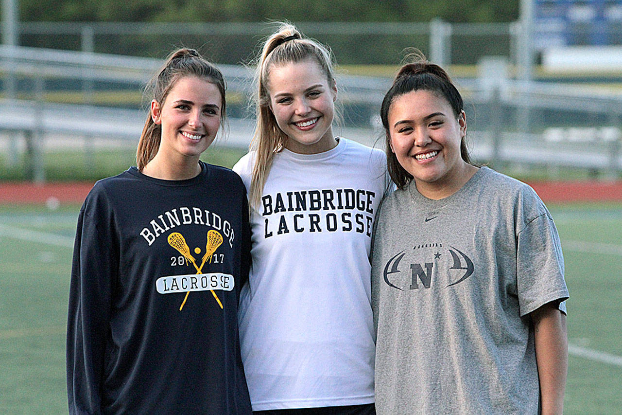 Spartan seniors Bella Jackson, Nina Davis and Thuy Lan Ortiz were honored during Senior Night when Bainbridge faced Roosevelt for its final regular season game in girls lacrosse last week. (Brian Kelly | Bainbridge Island Review)
