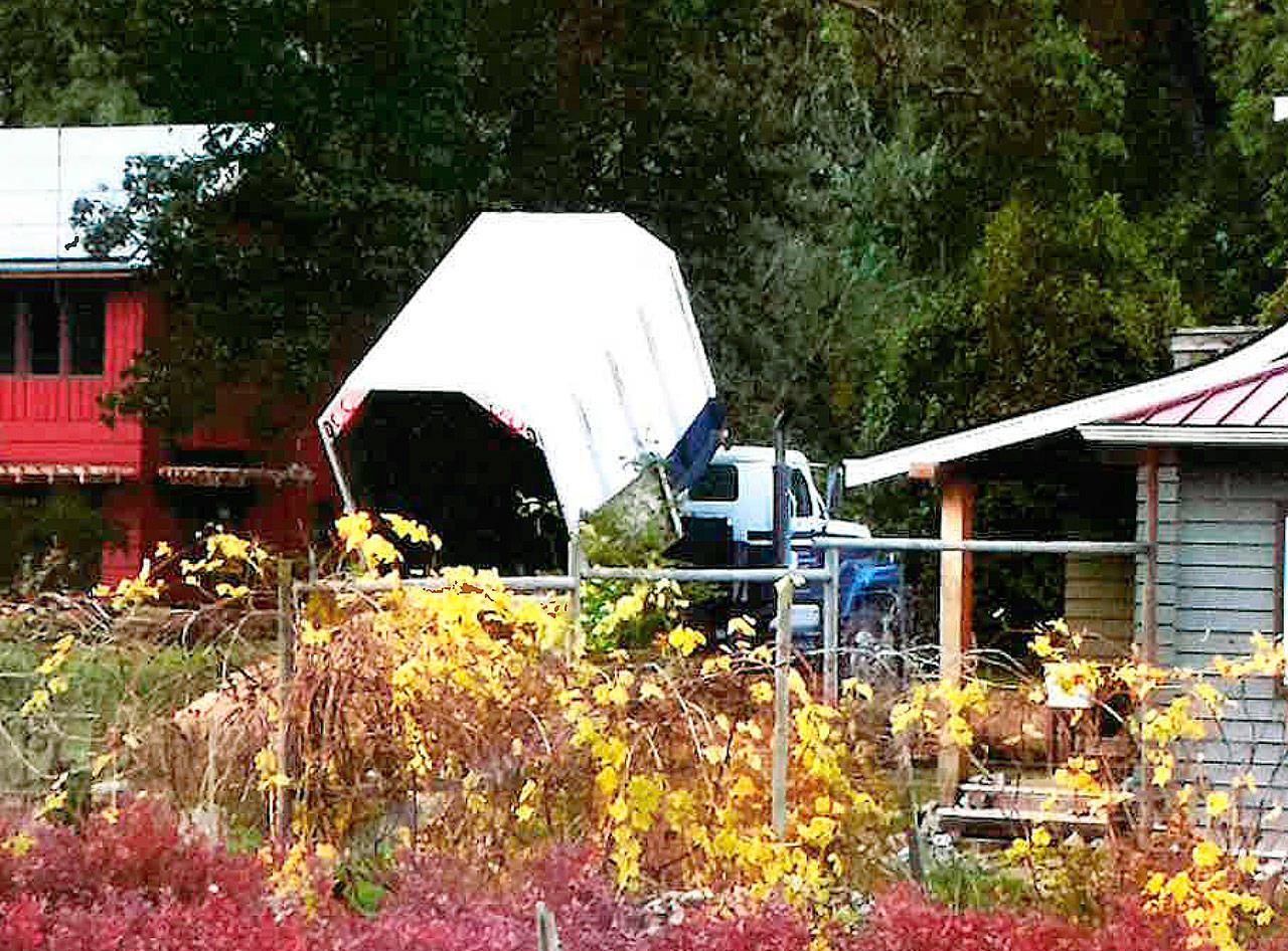 A city truck dumps wood chips on Councilman Ron Peltiers property in this photo given to Bainbridge police by a concerned resident. (Photo courtesy of the city of Bainbridge Island)