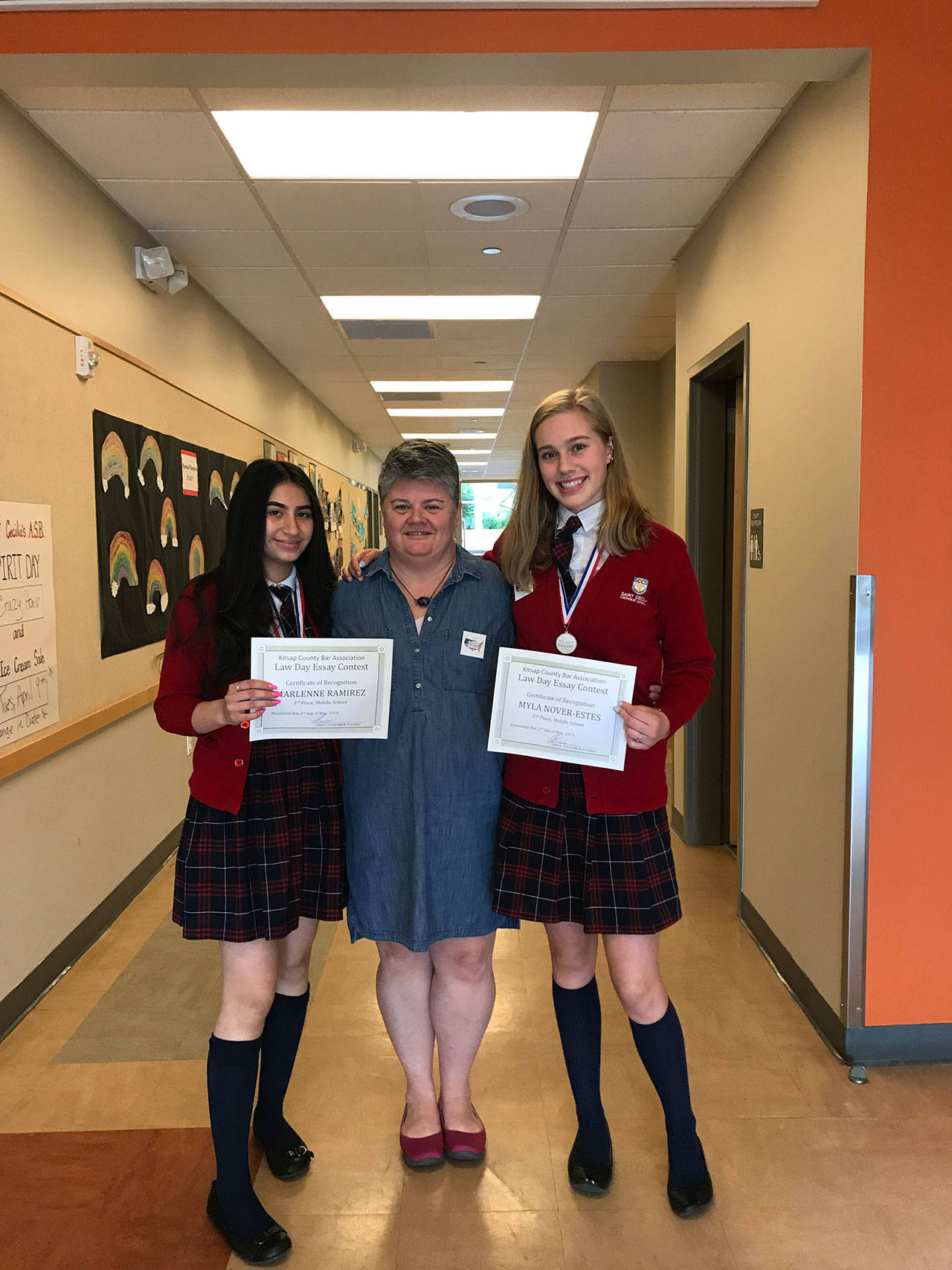 Photo courtesy of Susan Kilbane | Eighth graders Marlenne Ramirez and Myla Nover-Estes, with Saint Cecilia Catholic School teacher Amy Lee-Despard, winners of this years Law Day Essay Contest.