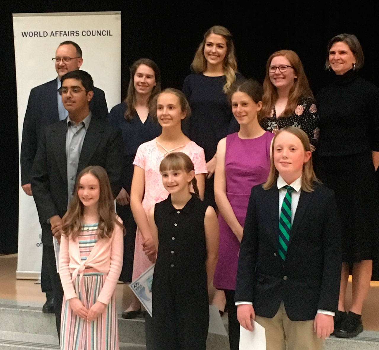 Hannah Cutler of Hyla Middle School (at far right in center row) stands with other winners of the World Affairs Councils 20th annual World Citizen Essay Contest. (Photo courtesy of Hyla Middle School)