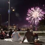 Luciano Marano | Bainbridge Island Review - A crowd gathers in the traffic lanes of the Winslow ferry terminal to watch the Grand Old Fourth fireworks show.