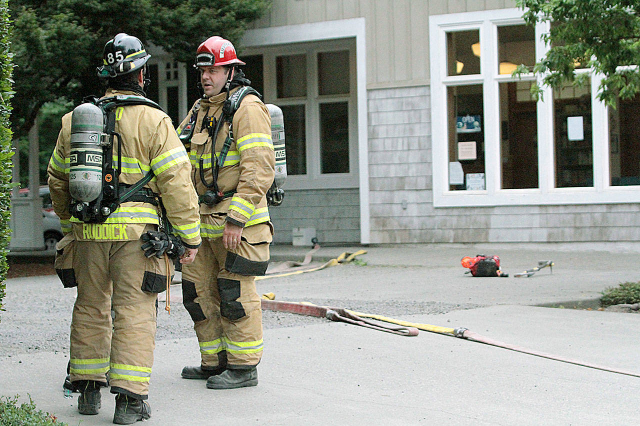 Bainbridge Island firefighters assess the situation at a hazmat spill at the Winslow Animal Clinic on Ericksen Way Tuesday. (Brian Kelly | Bainbridge Island Review)