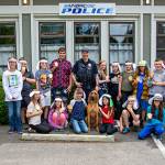 Pat Engaas photo | The latest group of Cops & Kids Camp attendees gather with Bainbridge Island Police Department K9 Officer Whitney and her human parter Officer Kurt Enget outside the station.