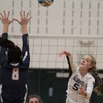 Izzy Prentice returns the ball against the Crusaders during ECs meeting with Bainbridge in Paski Gymnasium. (Brian Kelly | Bainbridge Island Review)