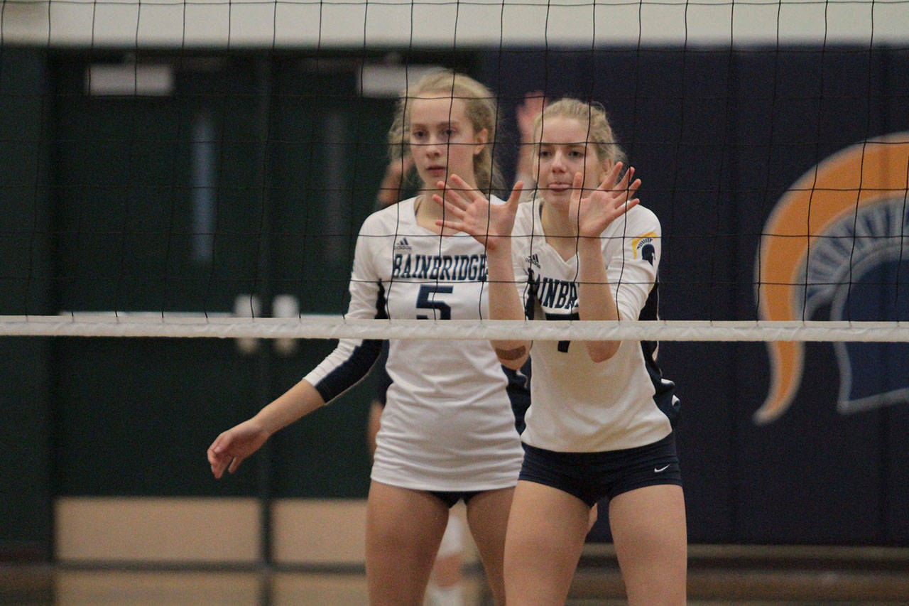 Izzy Prentice and Ava Targett guard the net for Bainbridge in action against Eastside Catholic. (Brian Kelly | Bainbridge Island Review)