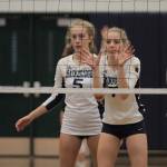 Izzy Prentice and Ava Targett guard the net for Bainbridge in action against Eastside Catholic. (Brian Kelly | Bainbridge Island Review)