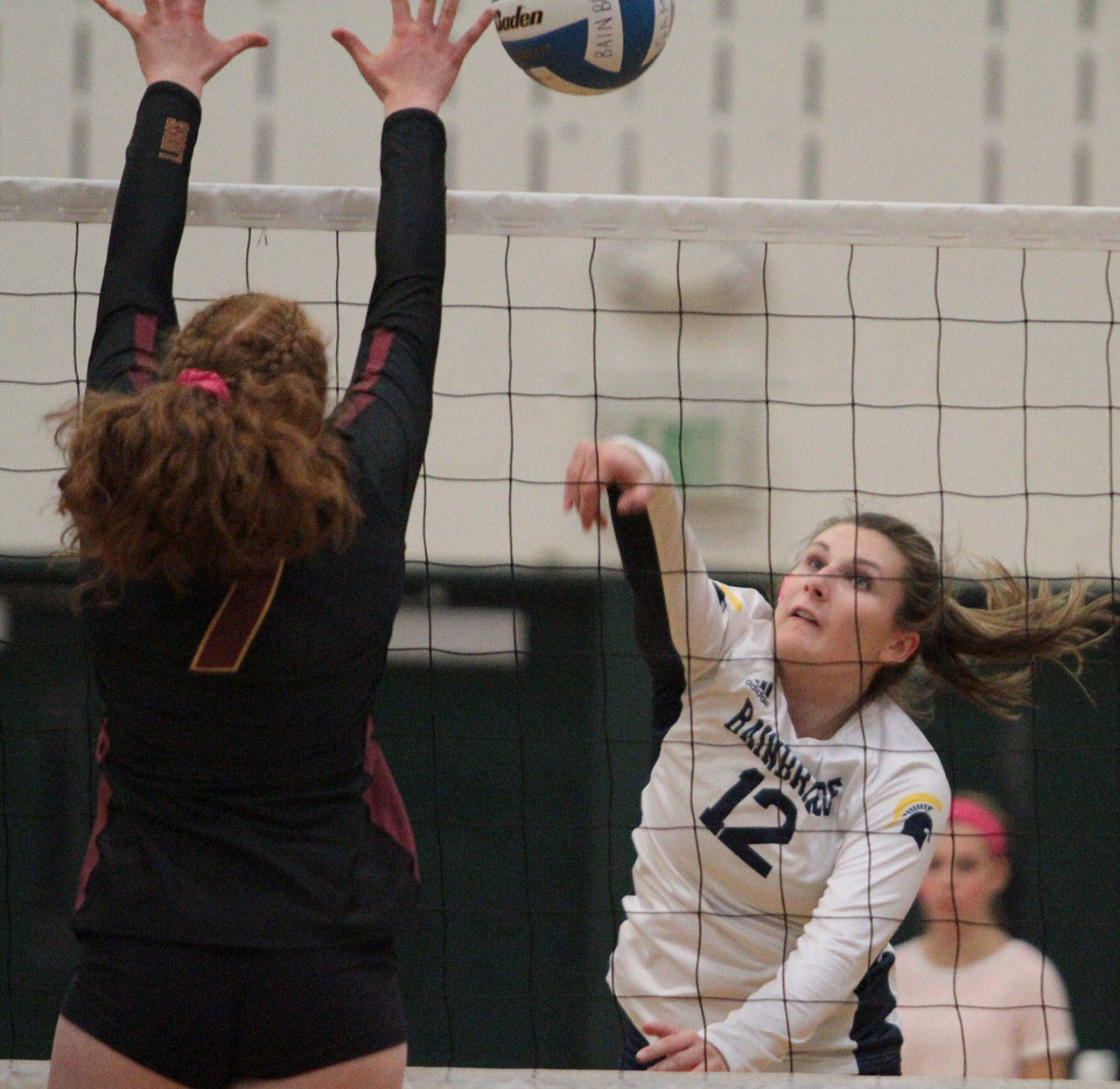 Julia Jakubik returns the ball for the Spartans. (Brian Kelly | Bainbridge Island Review)