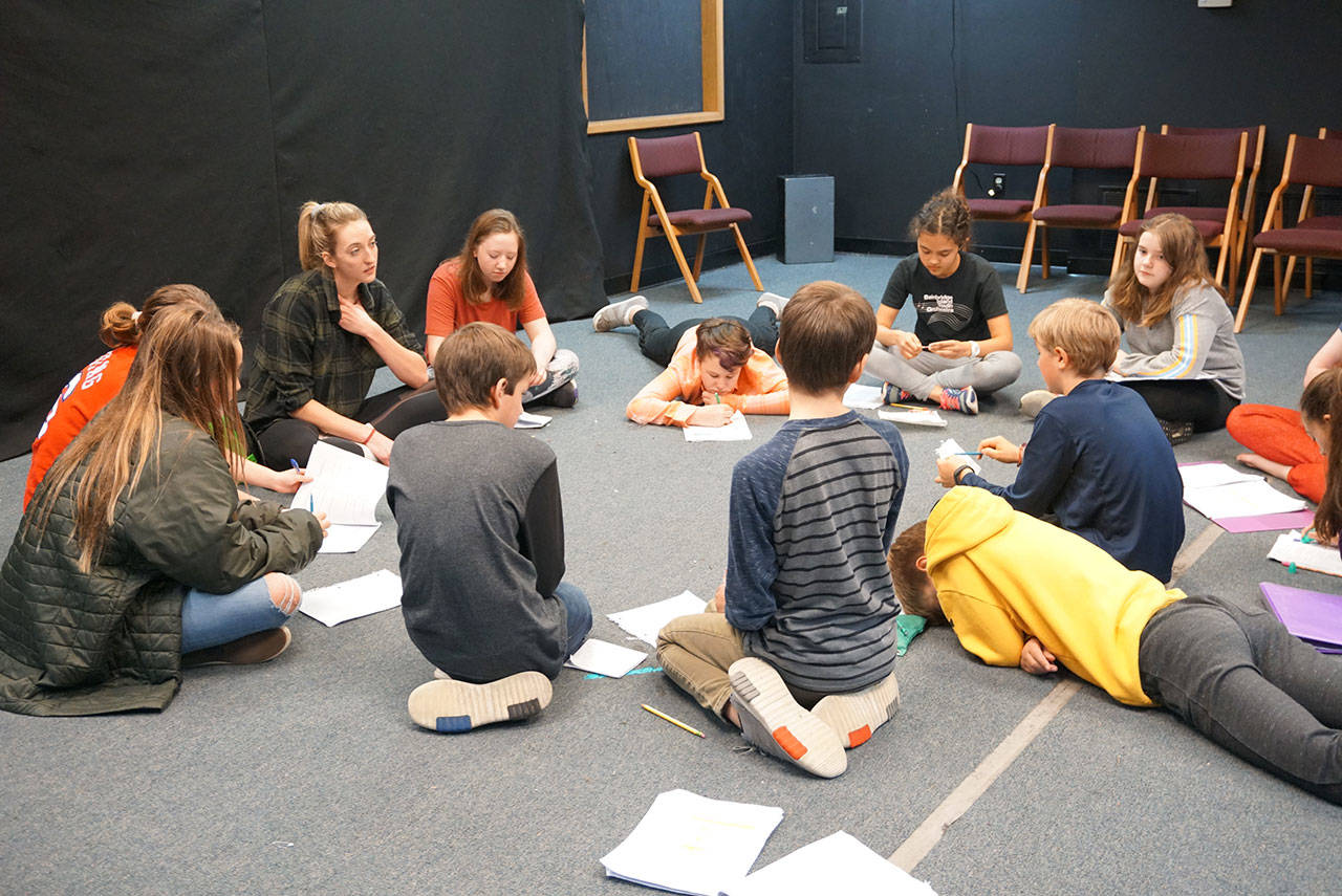 Luciano Marano | Bainbridge Island Review - The cast of B.I. Confidential read through lines during a recent rehearsal. The noir-style play, written by Scott Breitbarth, incorporates many trending topics from the Bainbridge Islanders Facebook groups page.