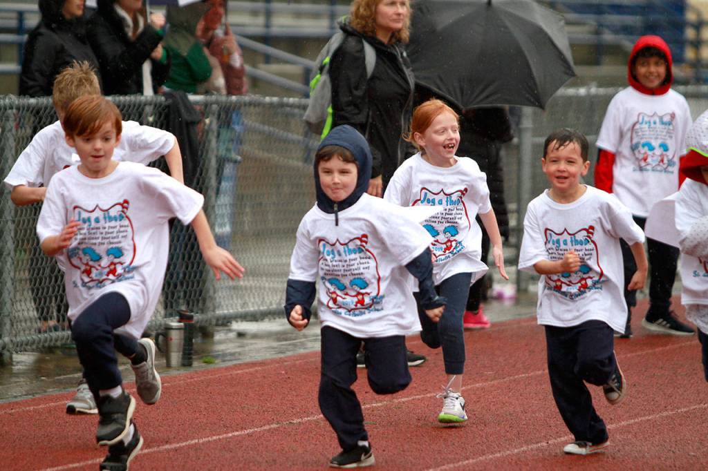 A drippy dash: St. Cecilia jog-a-thon returns to Bainbridge High School track | Photo gallery