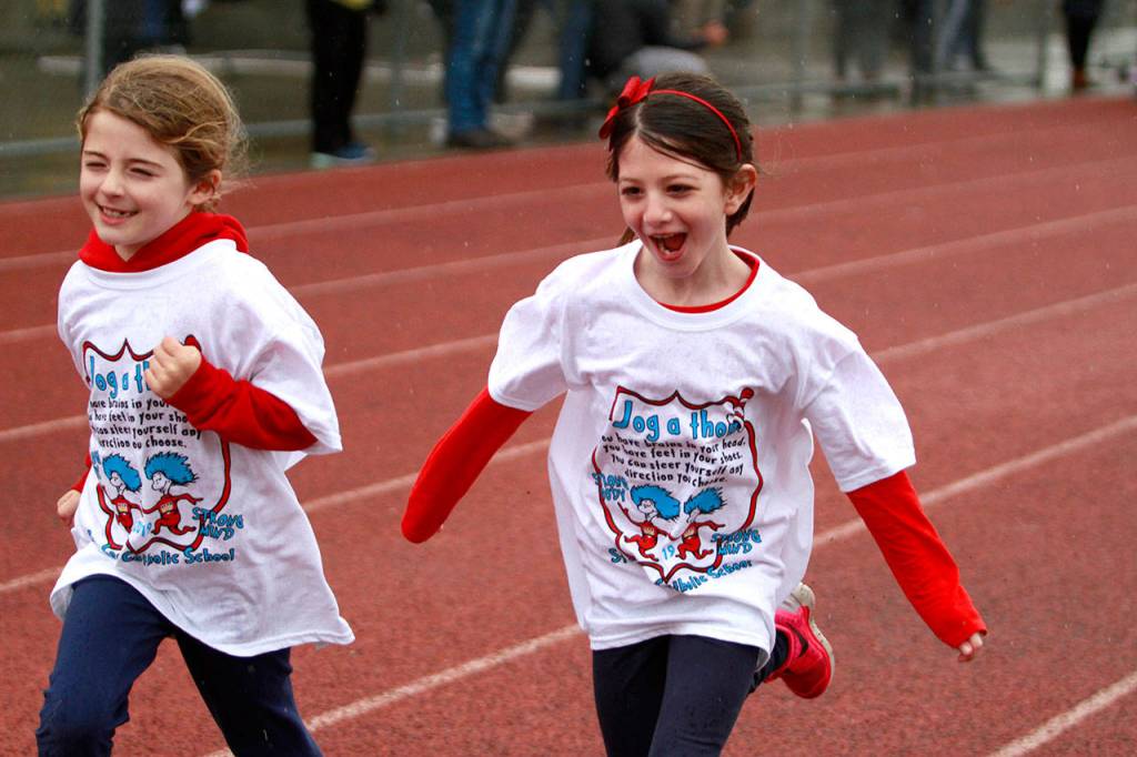A drippy dash: St. Cecilia jog-a-thon returns to Bainbridge High School track | Photo gallery