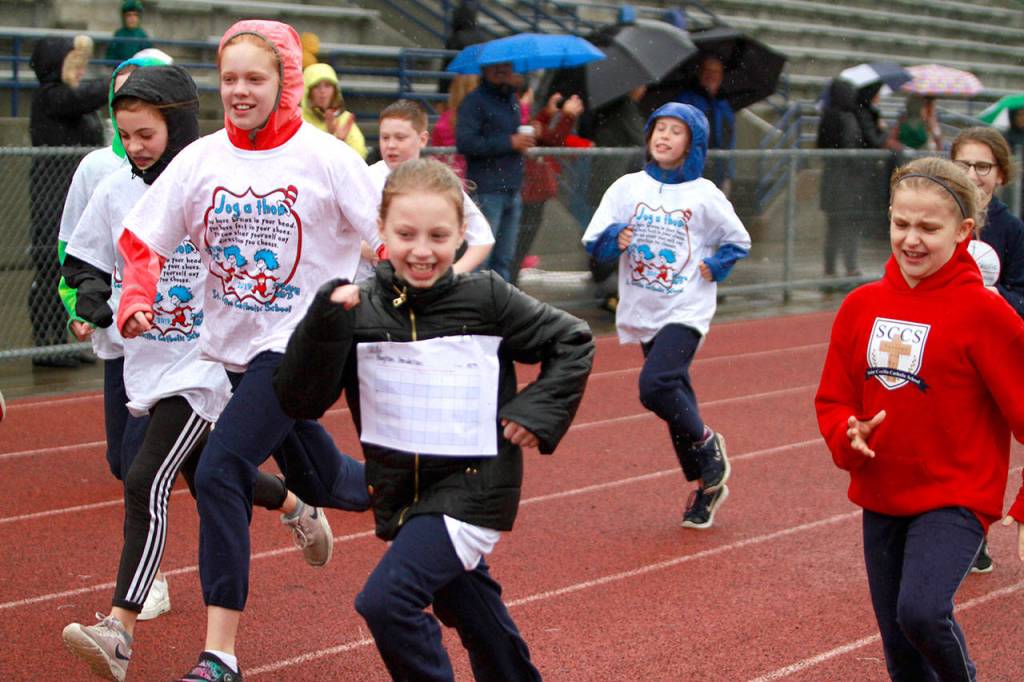 A drippy dash: St. Cecilia jog-a-thon returns to Bainbridge High School track | Photo gallery