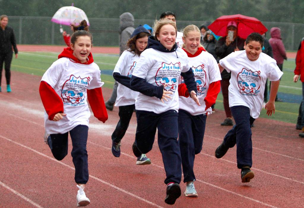 A drippy dash: St. Cecilia jog-a-thon returns to Bainbridge High School track | Photo gallery