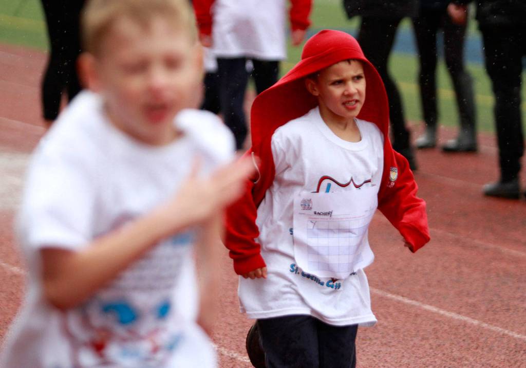 A drippy dash: St. Cecilia jog-a-thon returns to Bainbridge High School track | Photo gallery