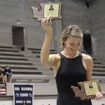Emily Silver holds up the Hall of Fame award for her sister, Helen Silver, during the pairs induction ceremony during the 2019 Girls State Swimming & Diving Championships. (Brian Kelly | Bainbridge Island Review)