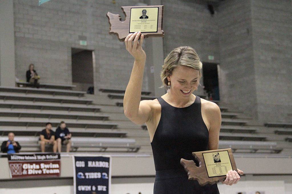 Emily Silver holds up the Hall of Fame award for her sister, Helen Silver, during the pairs induction ceremony during the 2019 Girls State Swimming & Diving Championships. (Brian Kelly | Bainbridge Island Review)